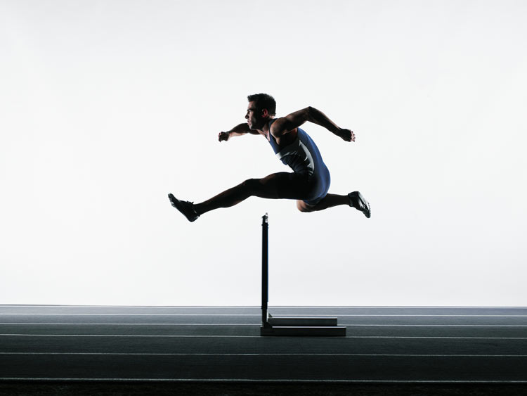 Runner jumping over a hurdle