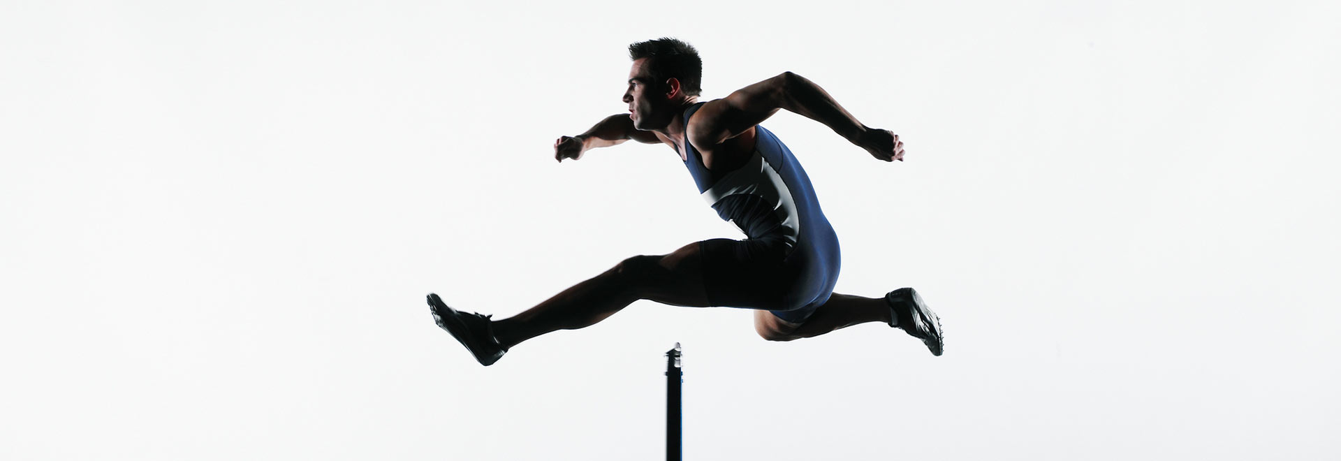 Runner jumping over a hurdle