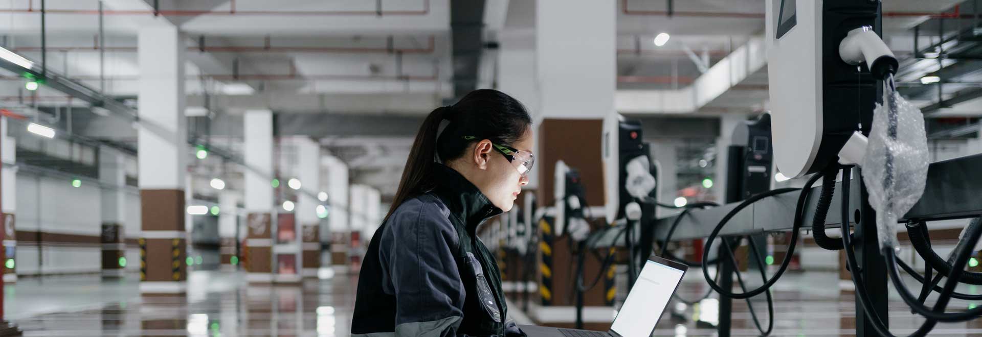 a female ingeneer checking alterative propulsion systems for a new car