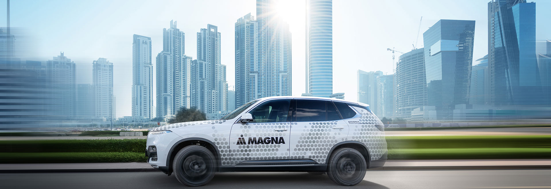 Magna Car is driving through a city
