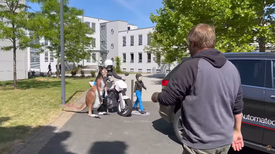 Kangaroo, person riding a motorcycle and a small child figures used for ADAS testing