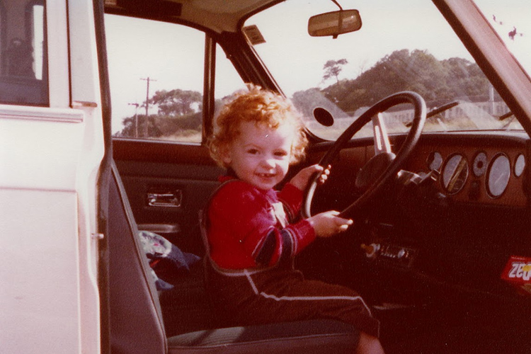 Steven Jenkins as a child pretending to drive a truck