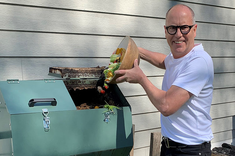John Oilar adding food waste to his composter