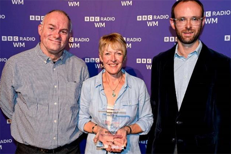 Two people presenting William Stirling with an award from BBC Radio