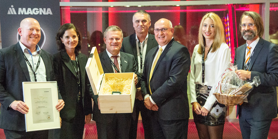 Group of people holding a certificate and trophy