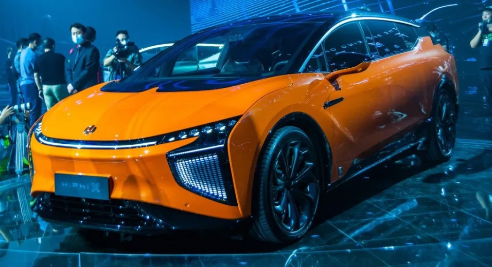 Orange vehicle on display at Auto Show
