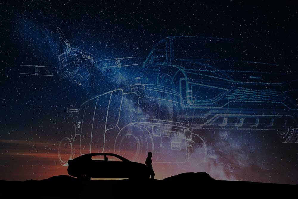 Silhouette of car and person looking at a constellation of stars in the sky
